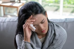 woman coughing headache